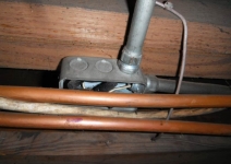 copper-pipe-contacting-the-front-of-an-uncovered-electrical-junction-box